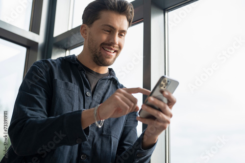 Businessman using phone in office