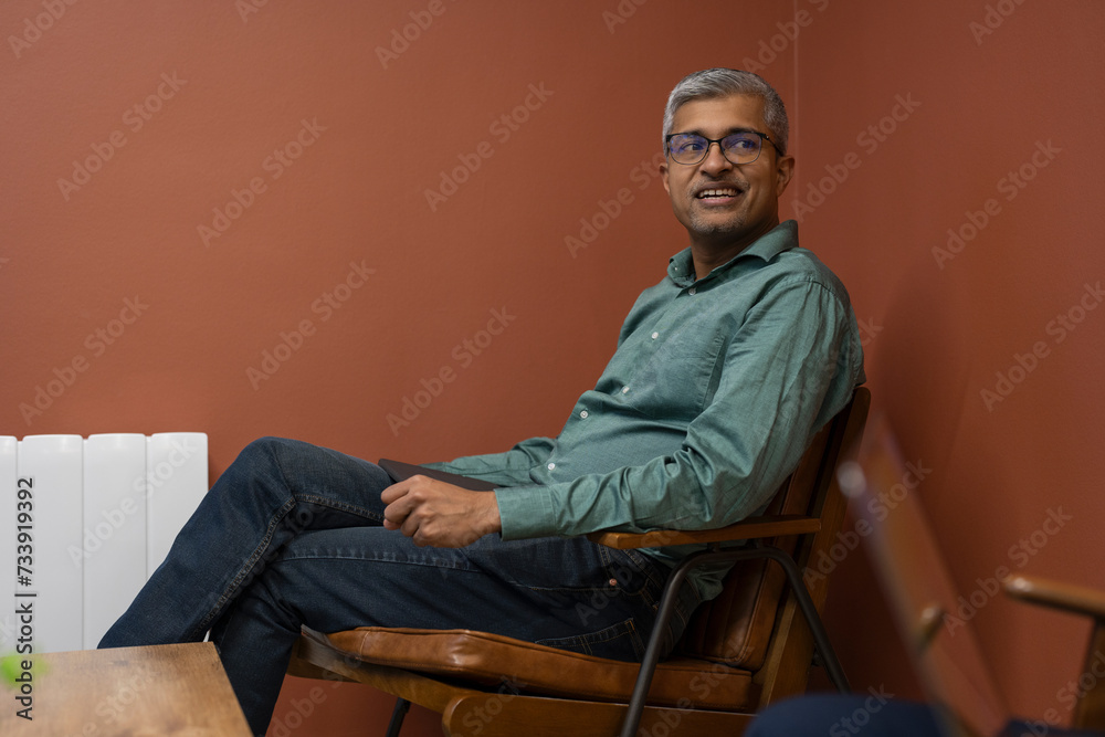 Fototapeta premium Mature businessman sitting in conference room