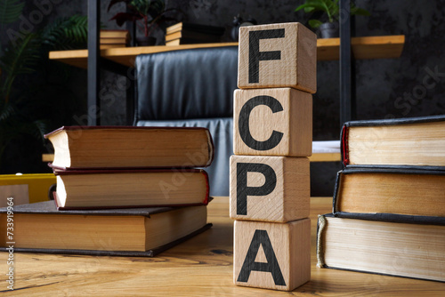 FCPA Foreign Corrupt Practices Act. Wooden cubes with letters on the office table. photo