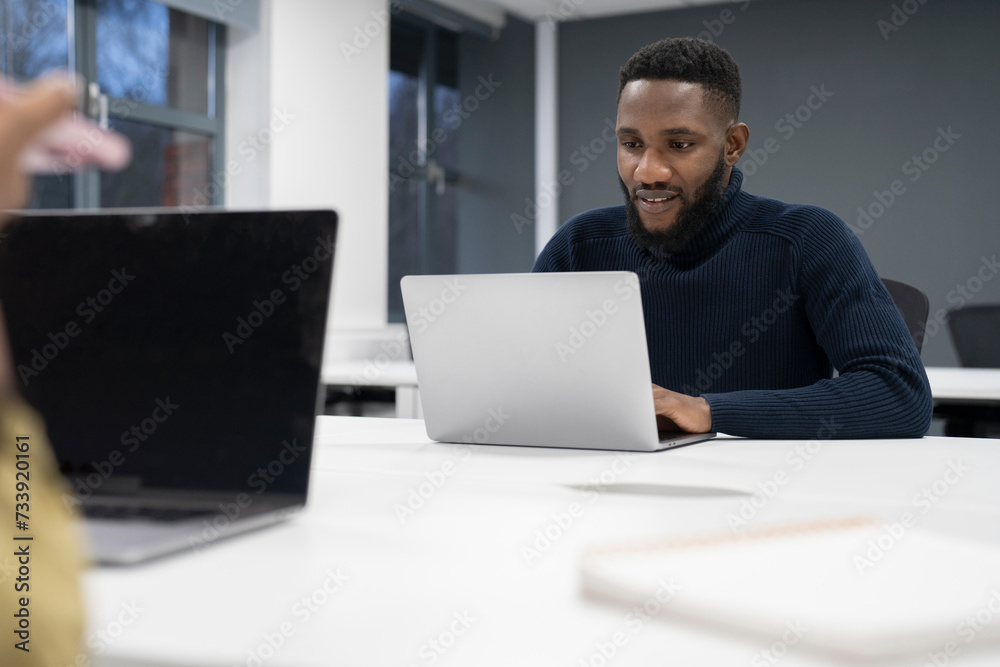 Businessman working on laptop in office Businessman working on laptop in office