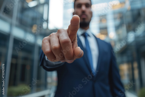 Businessman in Suit Pointing at Camera