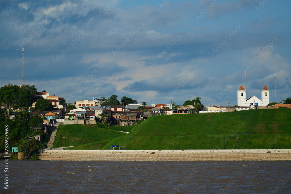 Obidos is a city and municipality in the state of Para, Brazil. View of the city skyline from the Amazon River with the St. Paul Apostle Parish church.
