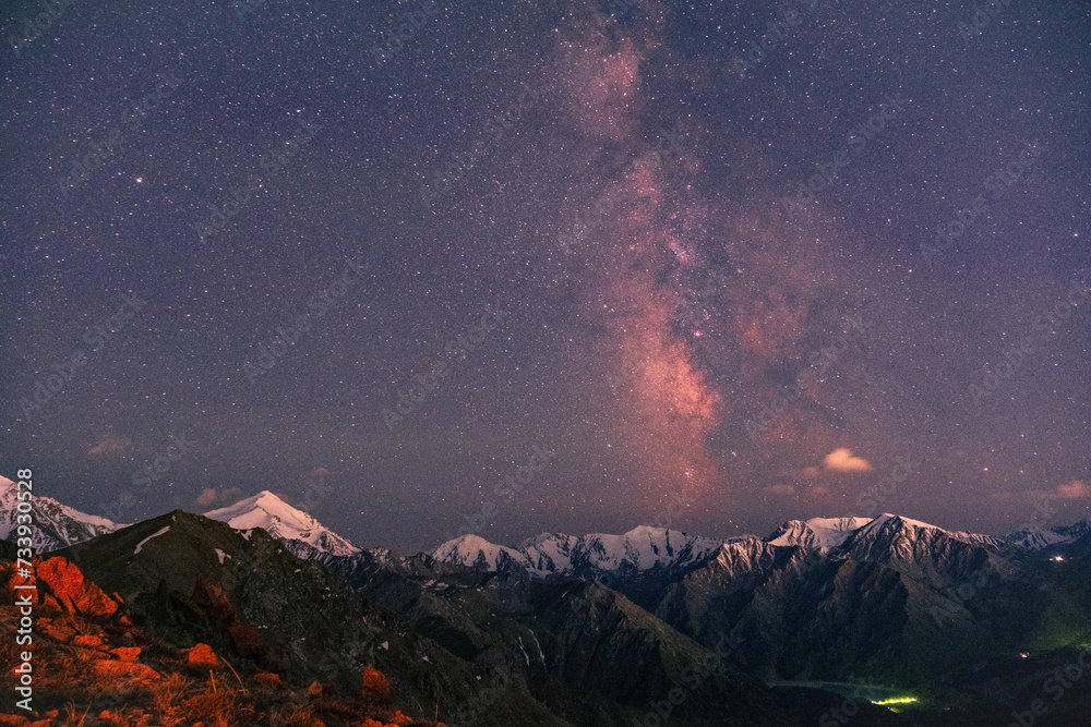 Wonderful atmosphere of snow-capped peaks and starry sky with the Milky Way before sunrise