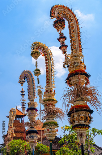 Traditional national Balinese decorations along the streets in Denpasar downtown.Tall bamboo poles with decoration are set in honour of hindu gods; cultural features of the island of Bali in Indonesia