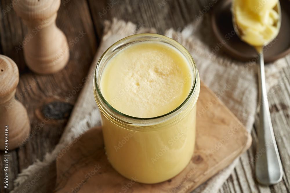 A jar of ghee or clarified butter on a table A jar of ghee or clarified butter on a table
