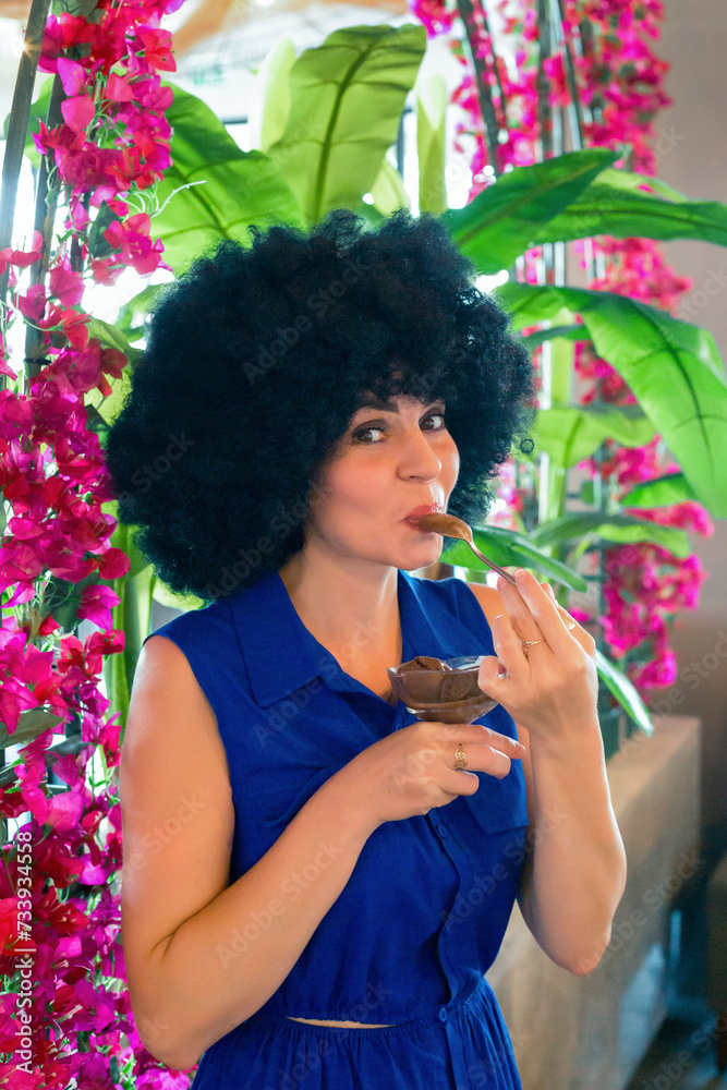 adult brunette woman eats ice cream with pleasure.