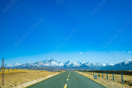 Shandan Military Horse Farm, Zhangye City, Gansu Province - Road under the snowy mountains of Qilian Mountains photo