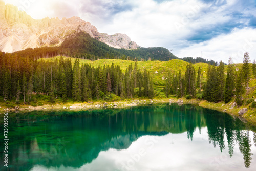 Carezza lake surrounded by forest and mountains in Dolomite alps, Italy © Maresol