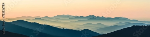 Mountain ridge panorama at twilight,  with silhouetted peaks against a fading sky © basketman23