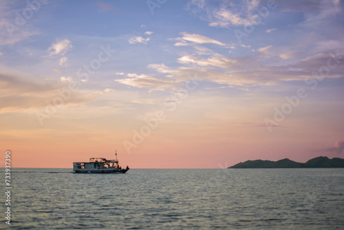 Boat Sailing Across The Sea With Beautiful Sunset In The Background © marselinuswahyu