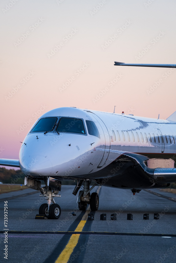 Small Jet Airplane on Runway at Sunset Small Jet Airplane on Runway at Sunset