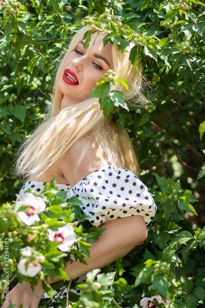 Garden Glamour: Blonde Woman in Polka Dot Ensemble Garden Glamour: Blonde Woman in Polka Dot Ensemble