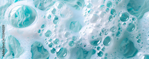 Macro photo of bubbles in water. Background with foam made of soap, shampoo, lotion, detergent in blue colour. Banner with copy space for laundry and cleaning services, spa, beauty, skin care concept.