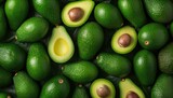Vibrant avocado background. Top view of fresh green avocados. Pattern with fresh sliced avocados. Perfect for banners and wallpapers.