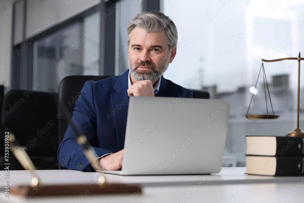 Handsome lawyer working at table in office Handsome lawyer working at table in office