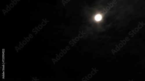 Moon and clouds in dark starry night