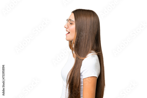 Teenager caucasian girl over isolated background laughing in lateral position