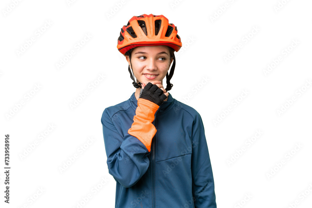 Teenager cyclist girl over isolated chroma key background looking to the side Teenager cyclist girl over isolated chroma key background looking to the side