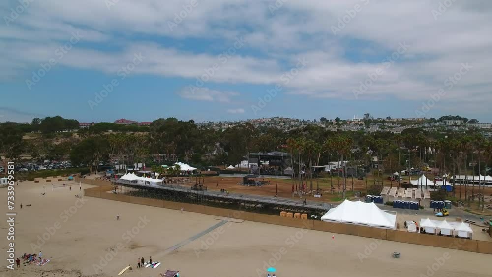 Aerial Panning Shot Of Male And Female Tourists At Beach On Vacation Under Cloudy Sky - Dana Point, California Aerial Panning Shot Of Male And Female Tourists At Beach On Vacation Under Cloudy Sky - Dana Point, California