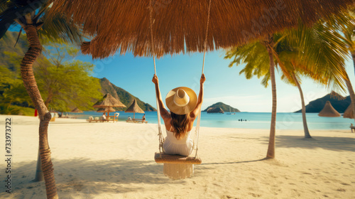 Beach holiday. A beautiful woman in a straw hat riding on a swing, enjoying the view of the beach ocean on a hot summer day. Perfect summer vacation. Travel agency poster
