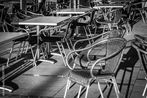 Empty tables and chairs in a restaurant.