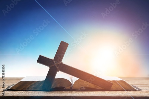Bright sunlight, holly bible and cross © BillionPhotos.com