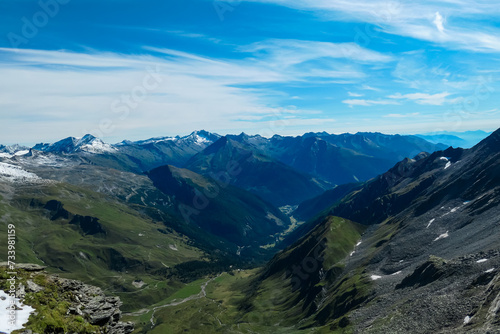 Panoramic view of majestic cloud covered mountain peaks of High Tauern, Carinthia Salzburg, Austria. Idyllic hiking trail in Goldberg group in wilderness of Austrian Alps. Tranquil mystical atmosphere