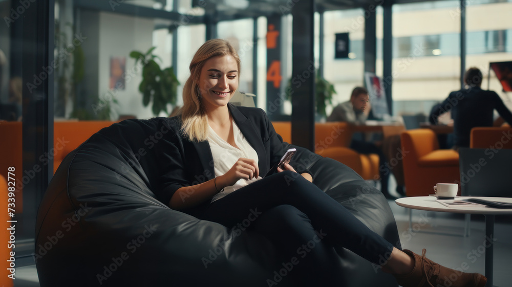 Smiling asian businessman using mobile phone sitting on bean bag in office Smiling asian businessman using mobile phone sitting on bean bag in office