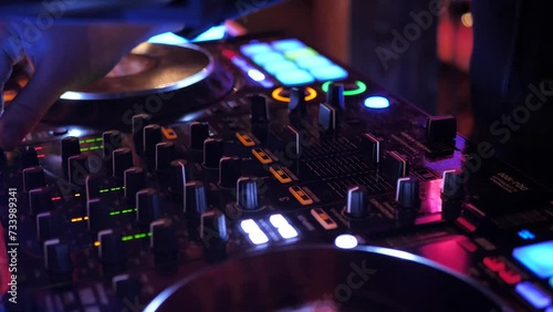 DJ mixes dance rhythm on mixing console photo