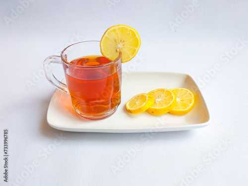 A cup of hot lemon tea on white background