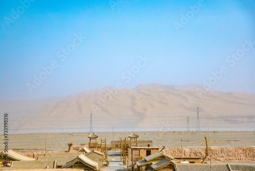 Dunhuang Silk Road Heritage City, Dunhuang City, Gansu Province - Buildings and sand dunes in the desert