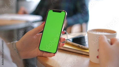 Businesswoman, hands or green screen phone in coffee shop, restaurant or cafe on social media app or calendar management. worker employee or mobile technology mockup of office logo on lunch break 4K