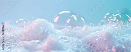 Frame with foam made of soap, shampoo, lotion, detergent on blue blurred backdrop. Macro photo of bubbles in water. Banner for laundry and cleaning services, spa, beauty and skin care concept. photo
