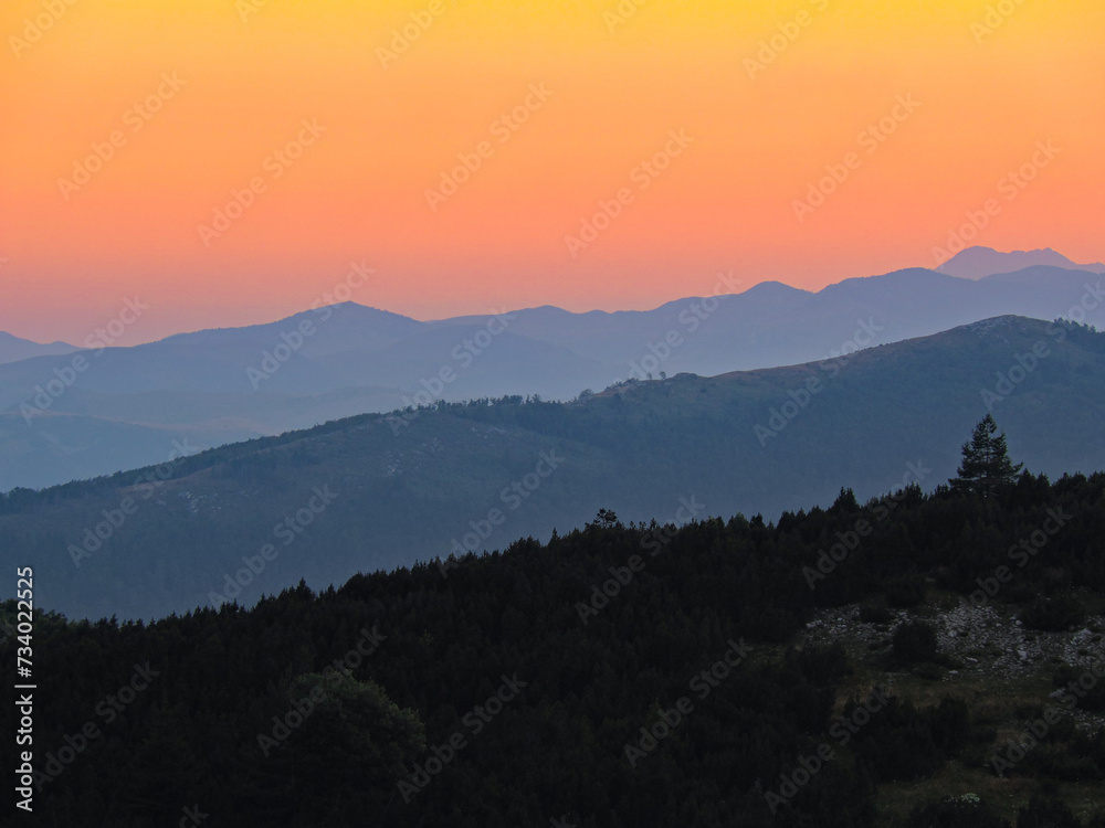 Three shades of sunset on the mountain.