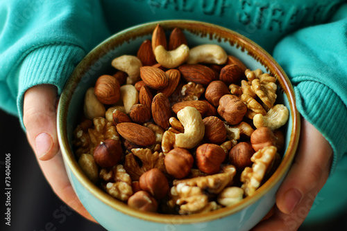 a plate of nuts. a nutritious and healthy snack. A mixture of walnuts, almonds, hazelnuts, cashews. Vegetarian food