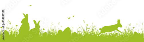 Easter banner or border with Easter bunnies and eggs on the grass