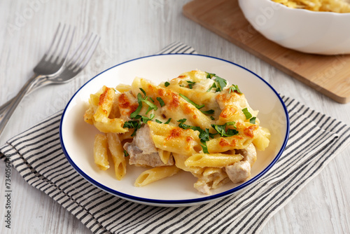 Homemade Cheesy Chicken Alfredo Pasta Bake on a Plate, side view.