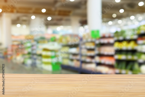 Empty wooden table with supermarket background for product display, space for text, empty wooden table with beautiful grocery storebackground
