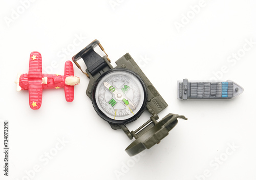 Flatlay picture of compass with miniature plan and ship. Marine and aviation navigation.