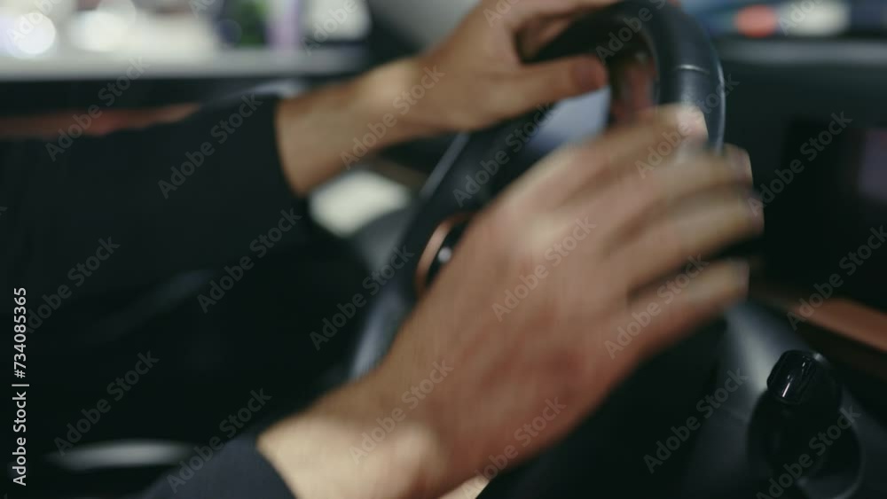 Male Hands Touching the Steering Wheel and Try All the Buttons for Serviceability. Man New Car Owner Testing the New Car, Looking If Everything Is Working. People and Car Dealership Concept