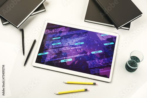 Modern digital tablet monitor with abstract programming language and world map, research and development concept. Top view. 3D Rendering