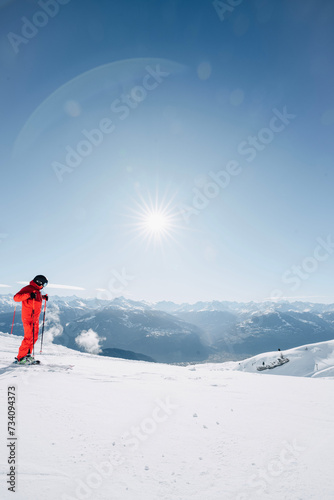 Skier hiking a snow-covered mountain in Switzerland in winter