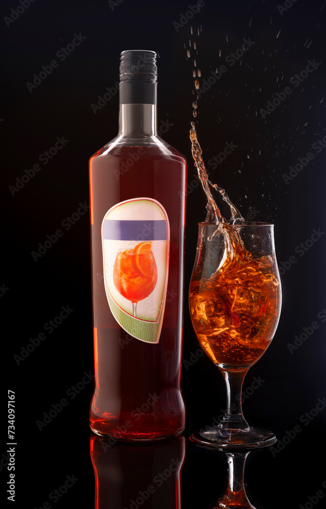 a bottle of liquor next to a glass of liquor