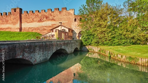 CASTELFRANCO VENETO, ITALY - APRIL 21 2018: Osteria Maniscalco and bridge on Via Francesco Maria Preti, 66 near Section of the walls in Castle of Castelfranco Veneto. photo