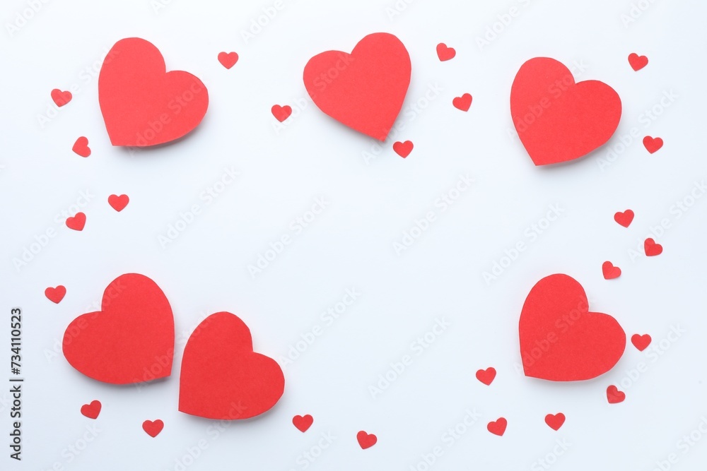Frame of beautiful red paper hearts on white background, flat lay. Space for text
