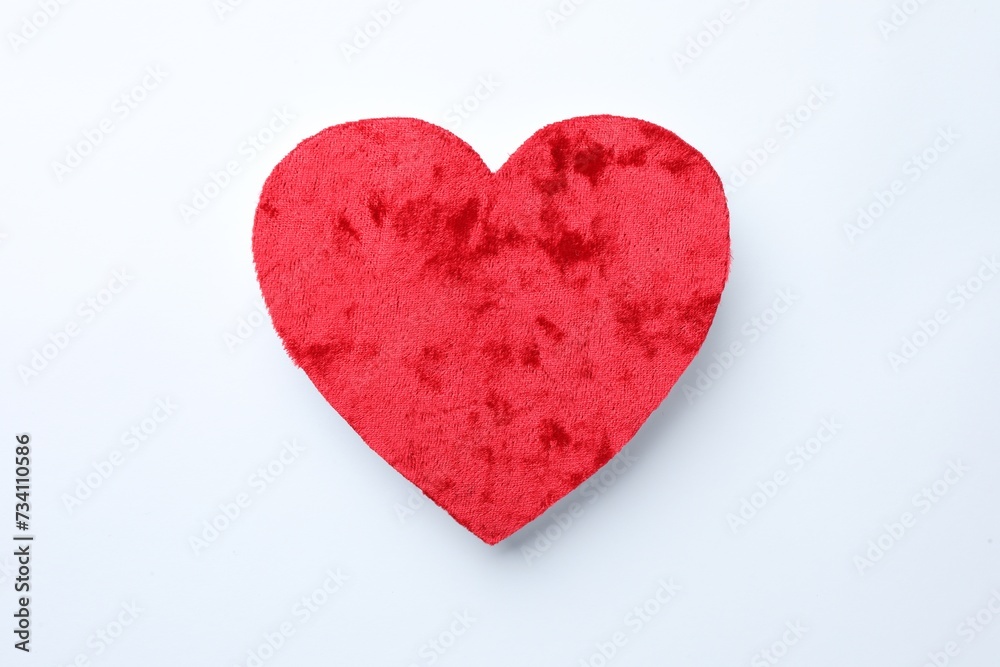 One velvet heart on white background, top view One velvet heart on white background, top view