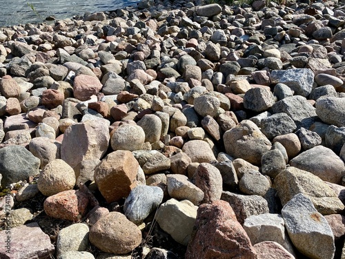 wet small stones lying on road in large reservoir