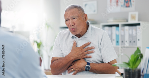 Senior, man and consulting doctor on chest pain, sore or discomfort in healthcare hospital. Mature, male person or patient talking to medical employee for heart ache, breathing or illness at clinic