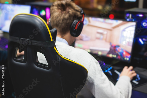 Cyber sport e-sports tournament, team of professional players, gamers playing online esports championship in competitive moba, strategy fps game in a cyber games arena club, person in a chair with pc