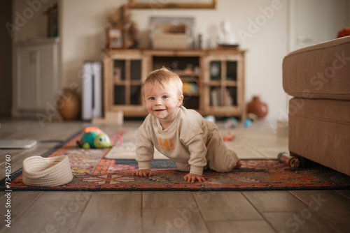Happy baby crawling in living room